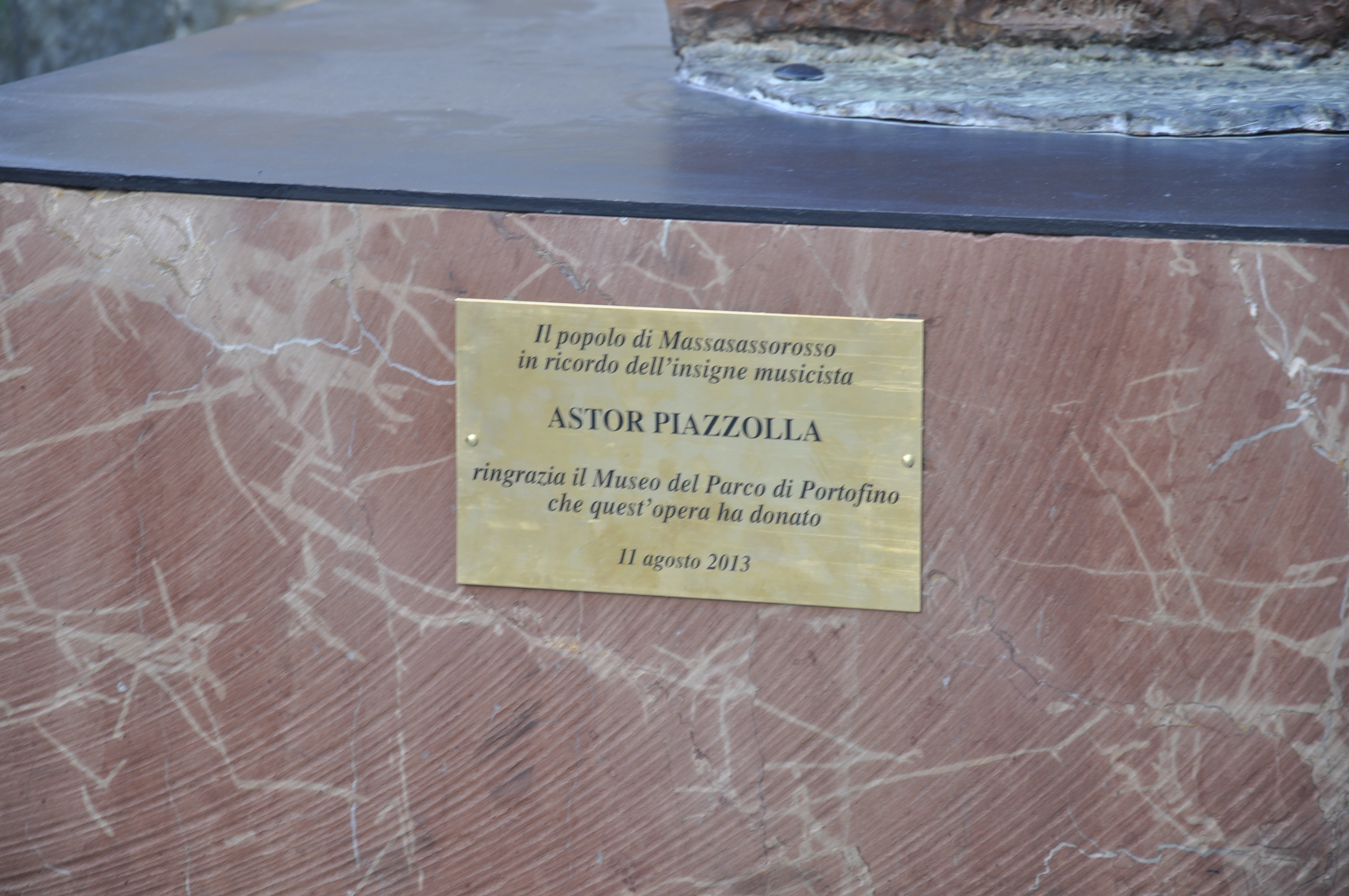 Bronze plaque set into stone commemorating Astor Piazzolla in Massa Sassorosso, Italy.