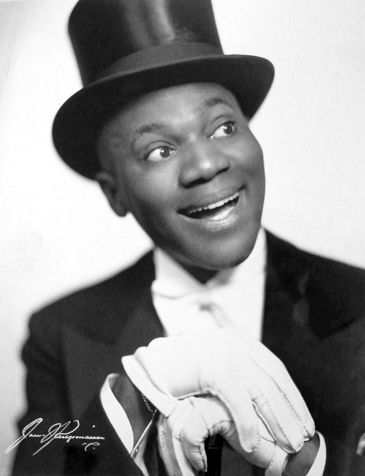Studio portrait of Bill Bojangles Robinson standing in a dance pose in 1942