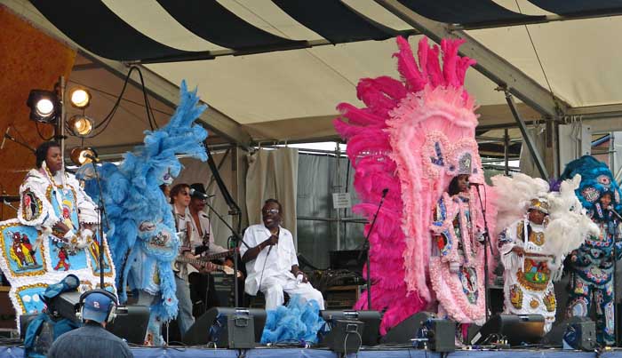 The Wild Magnolias performing in colorful Black Masking Indian suits at the New Orleans Jazz & Heritage Festival in 2006