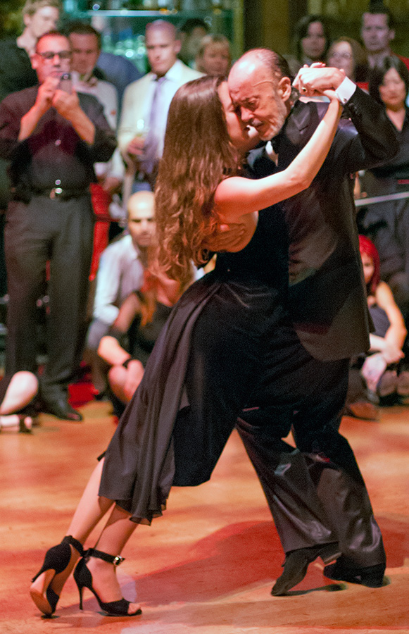 Carlos Gavito and María Plazaola walking in close embrace during a Stockholm demonstration.
