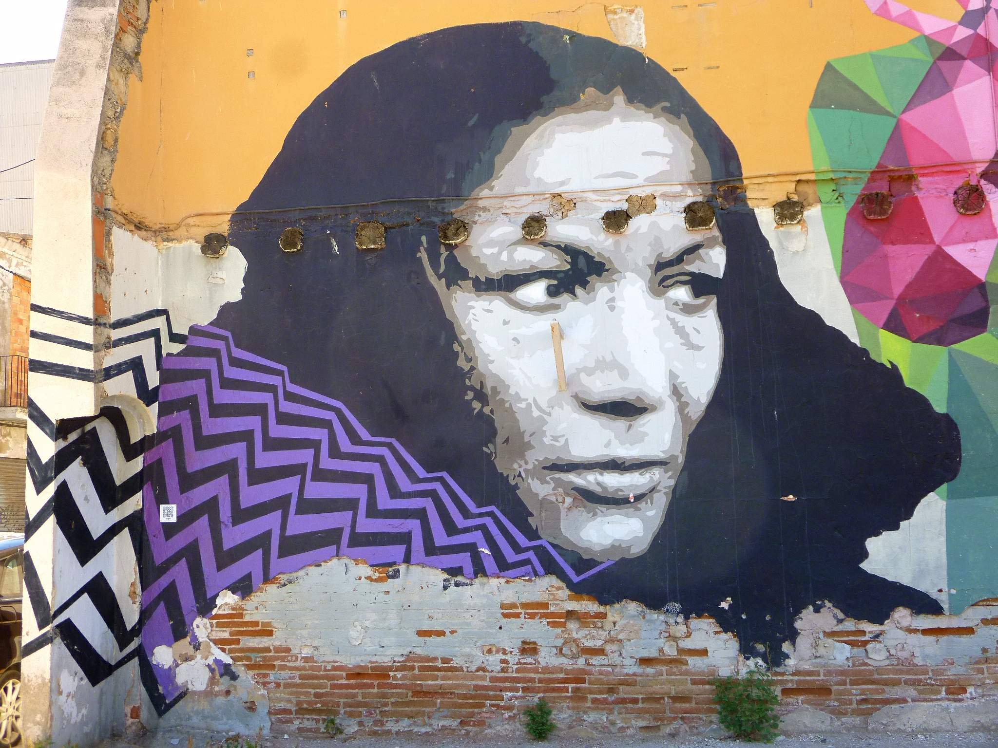 Colorful Barcelona street mural portraying Carmen Amaya's face.