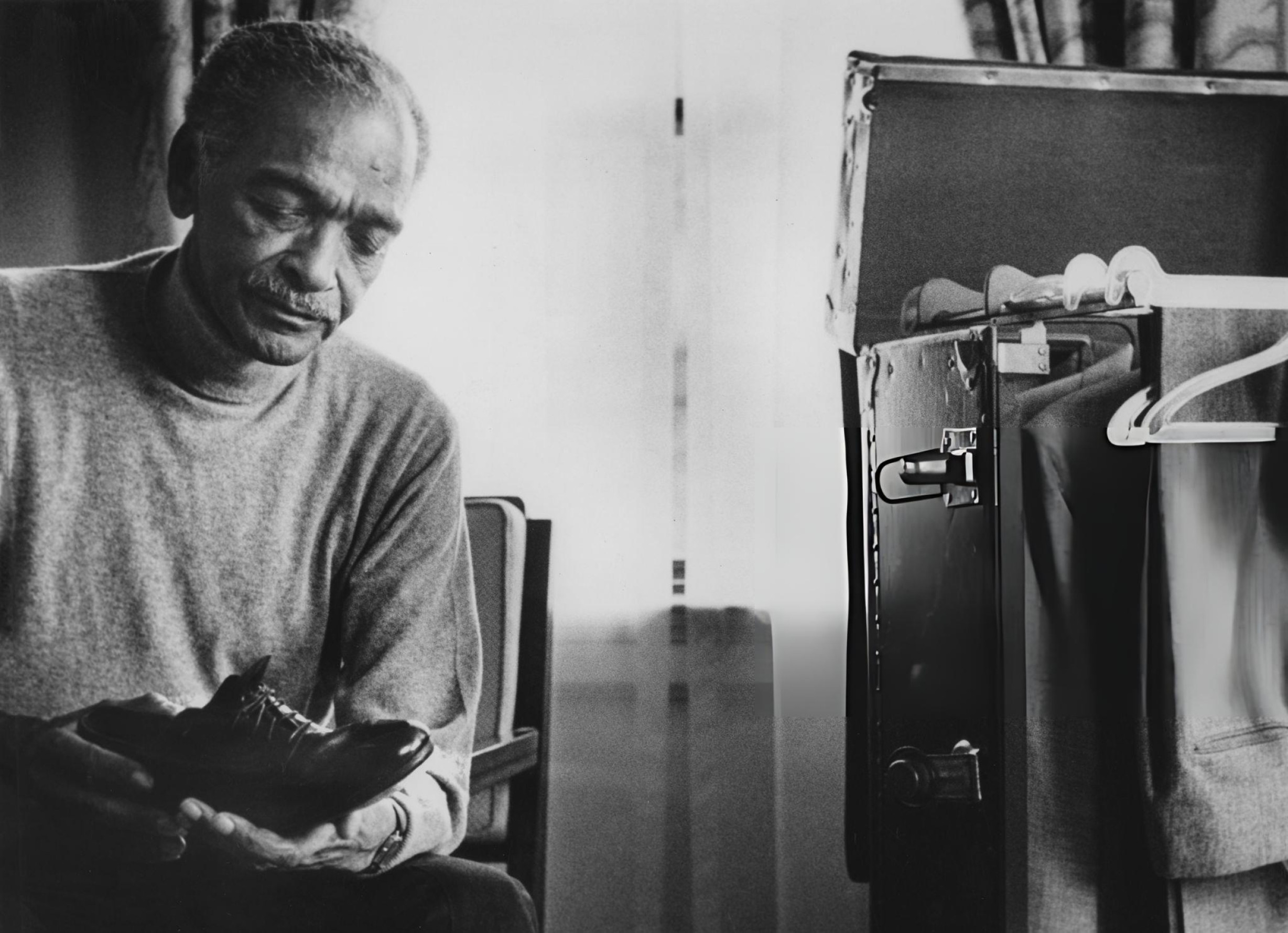 Charles Honi Coles examining his tap shoes in 1985