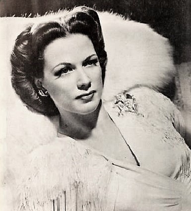 Black-and-white 1941 studio portrait of Eleanor Powell wearing a light fur wrap.
