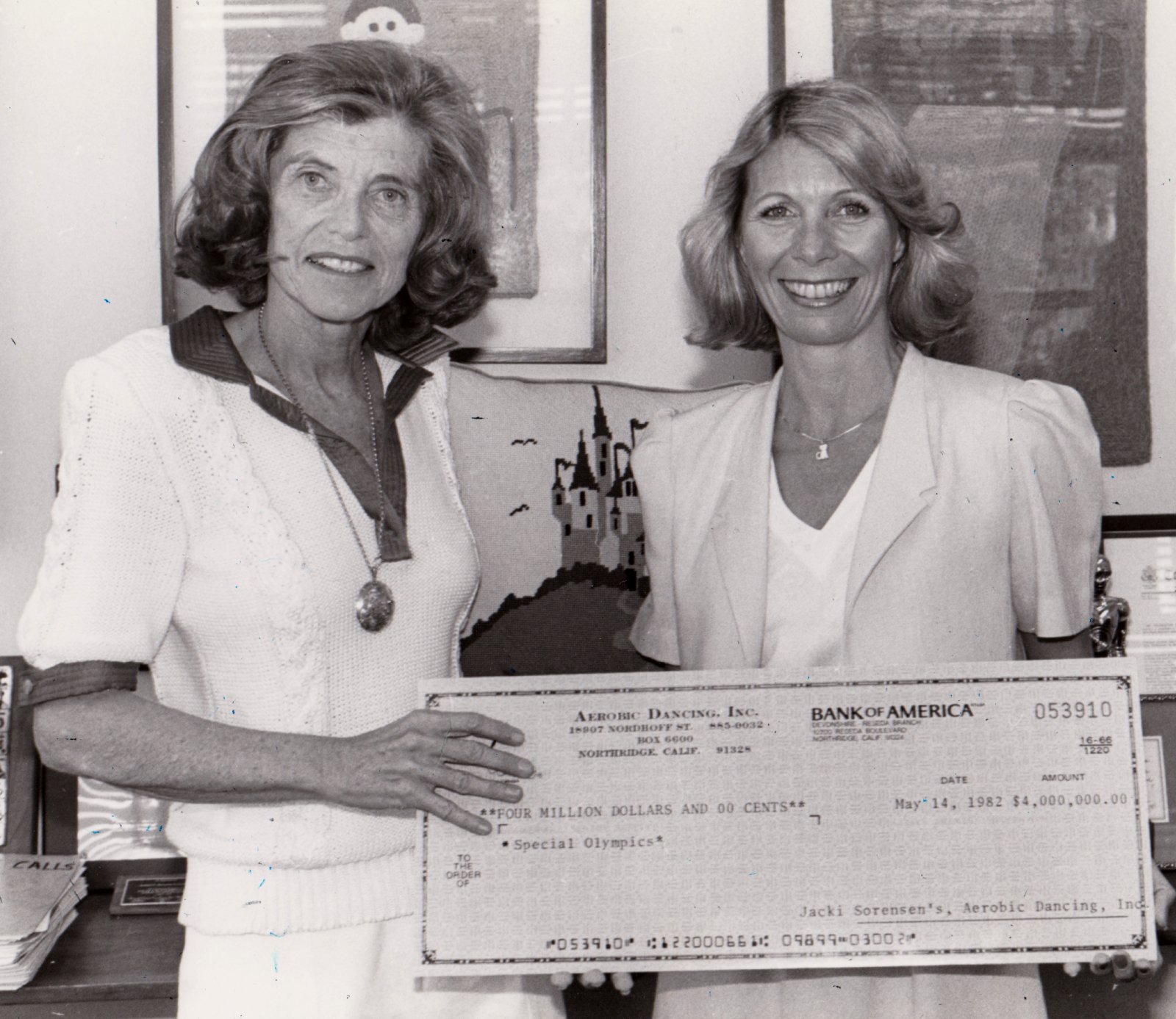 Eunice Kennedy Shriver and Jacki Sorensen holding a Special Olympics fundraising check in 1982