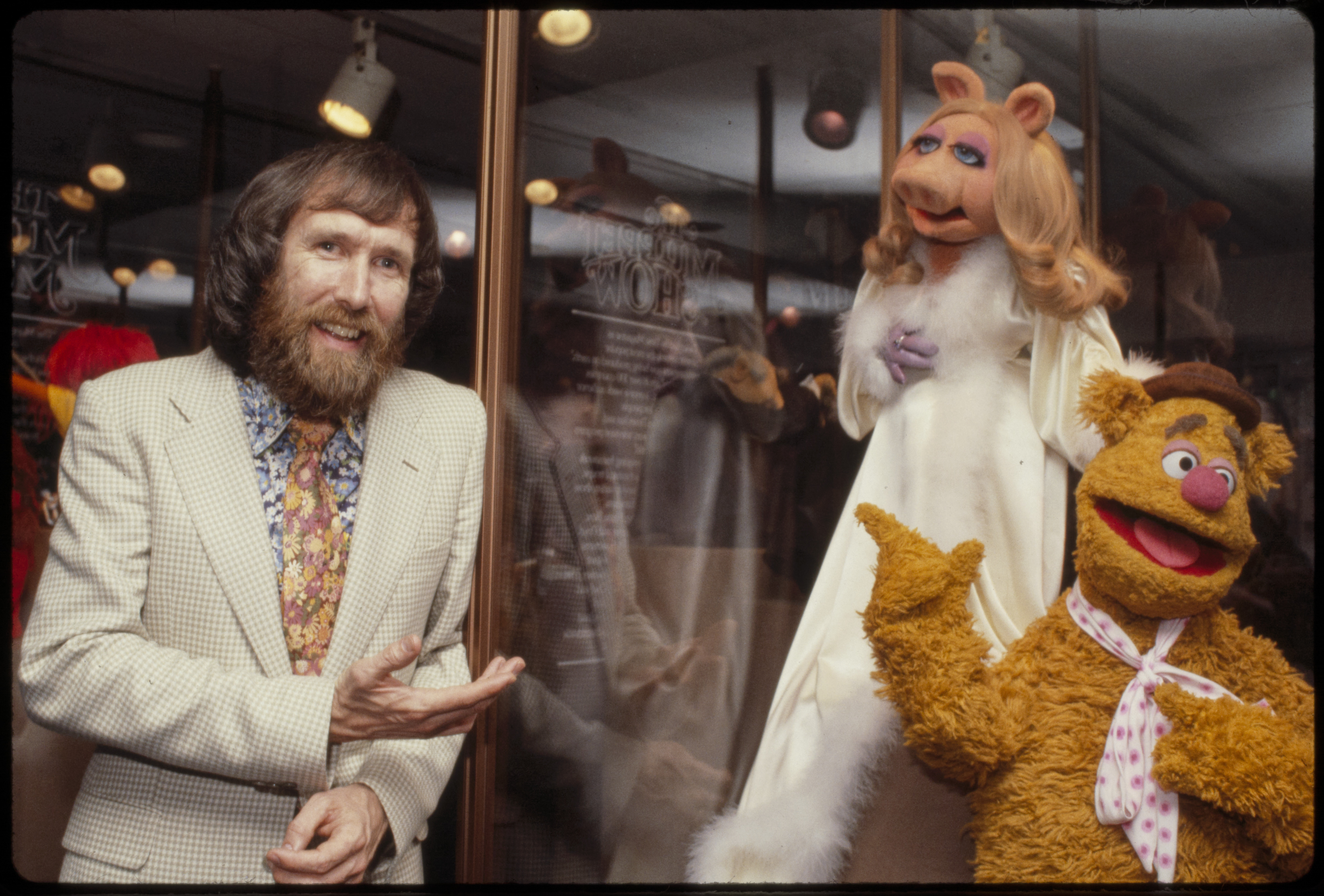 Jim Henson smiling beside several Muppet characters in a 1979 studio portrait