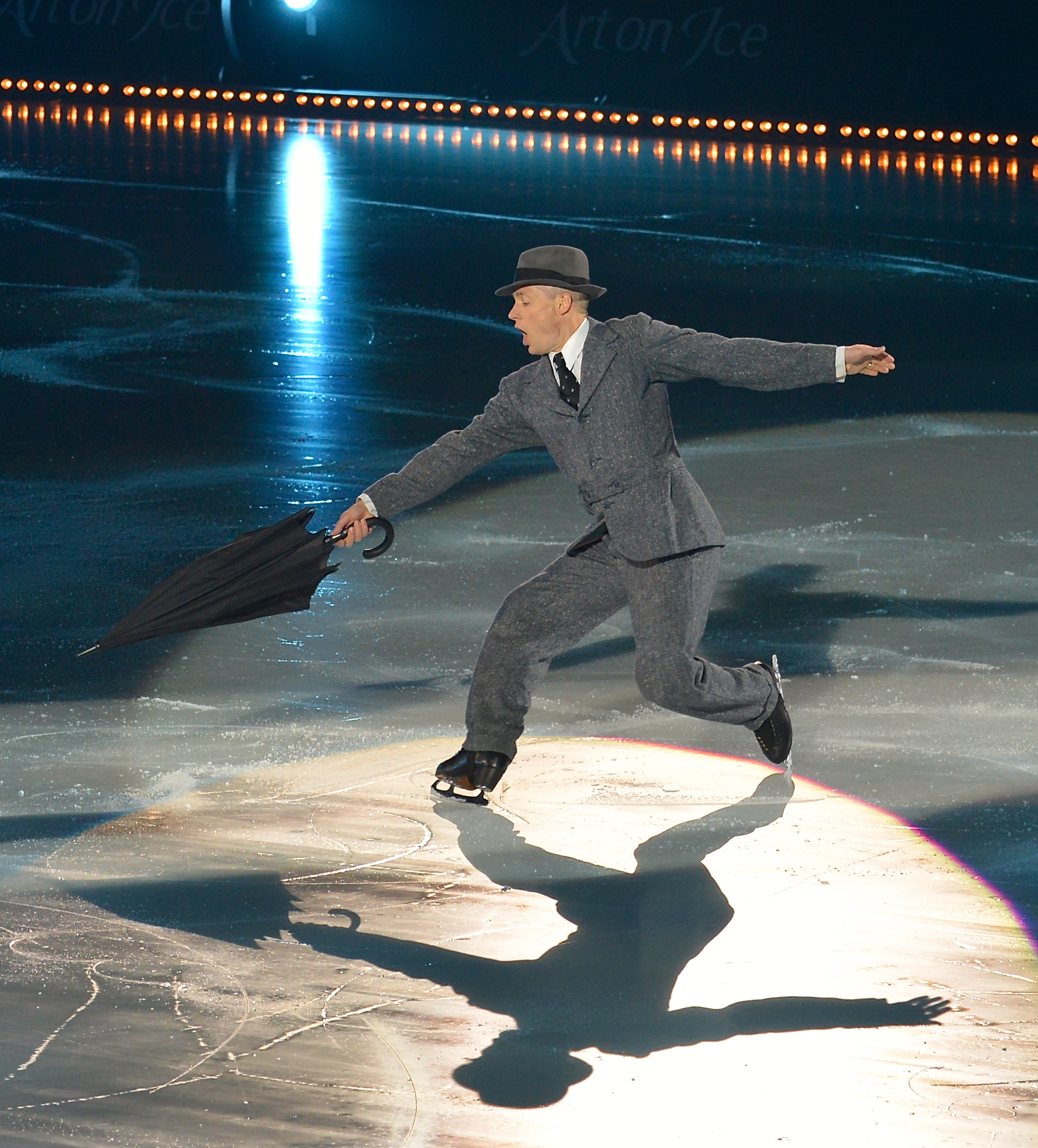 Kurt Browning skating with a closed umbrella during Singing in the Rain at Art on Ice in 2014