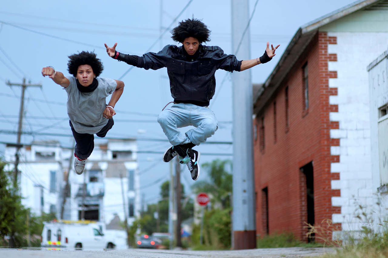 Laurent and Larry Bourgeois jumping side by side outdoors