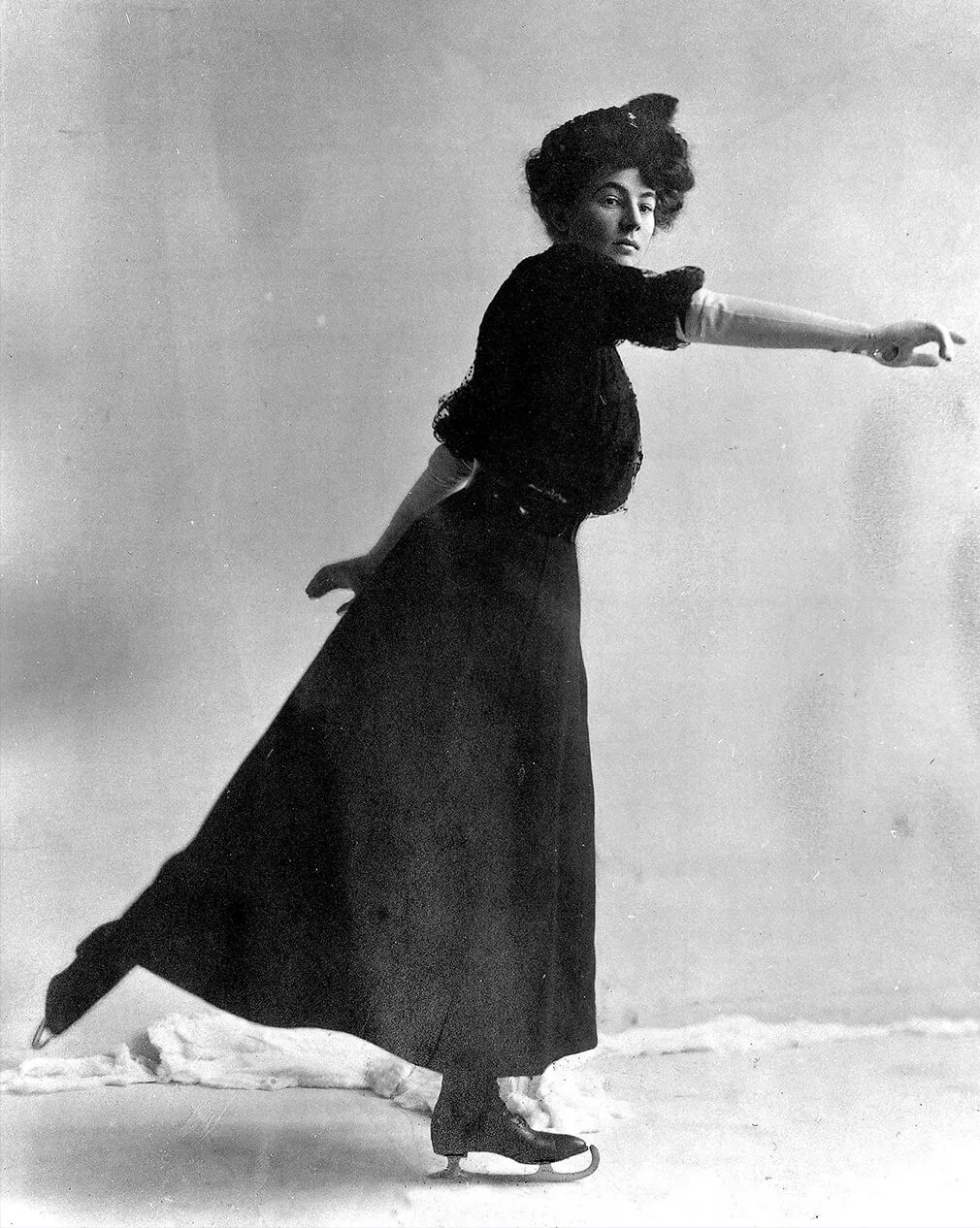 Historical full-length portrait of British figure skater Madge Syers on the ice
