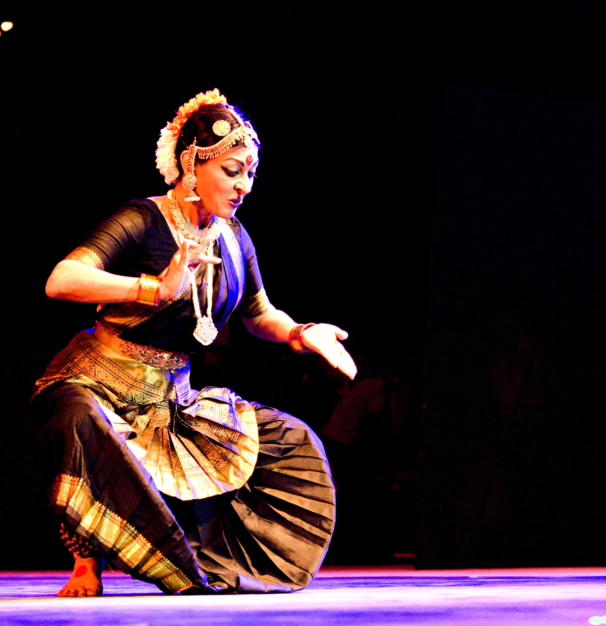 Mallika Sarabhai performing in a blue sari onstage at Saarang 2011