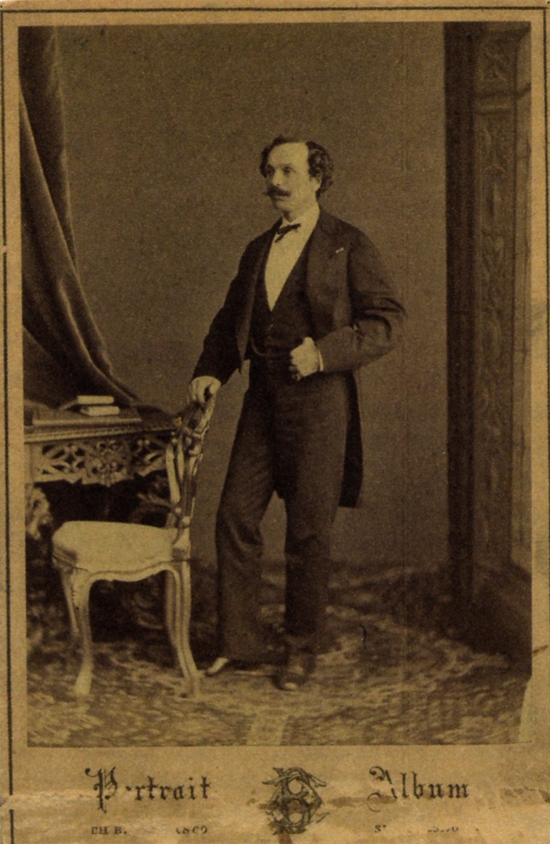 Full-length studio portrait of Marius Petipa standing beside a chair, circa 1855