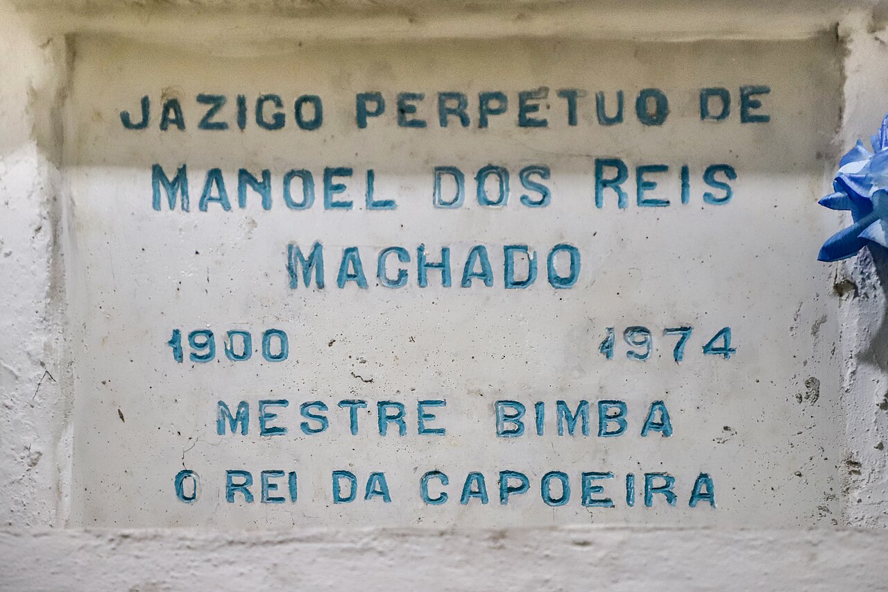 The inscribed tomb of Mestre Bimba inside the Church of Our Lady of Mount Carmel in Salvador, photographed at an angle.