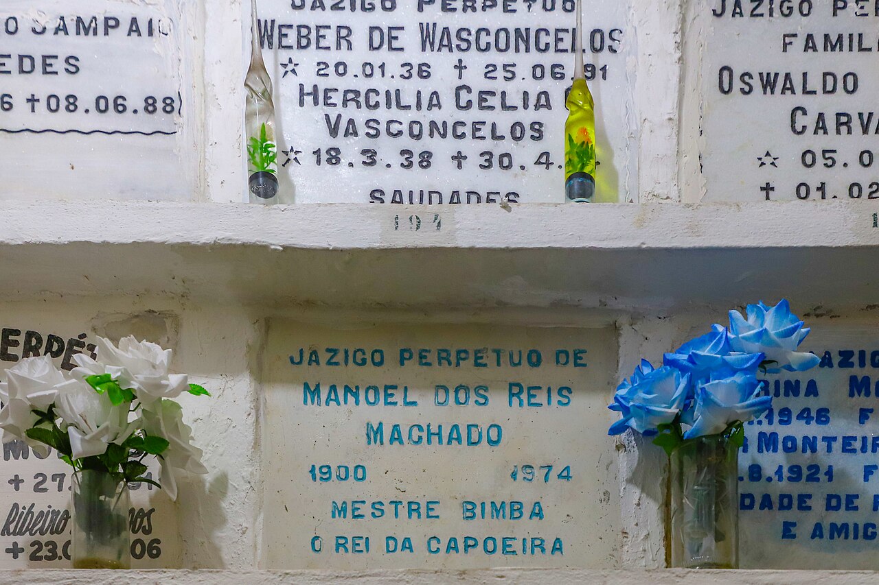 A wider view of Mestre Bimba's tomb and memorial inscription inside the Church of Our Lady of Mount Carmel in Salvador.