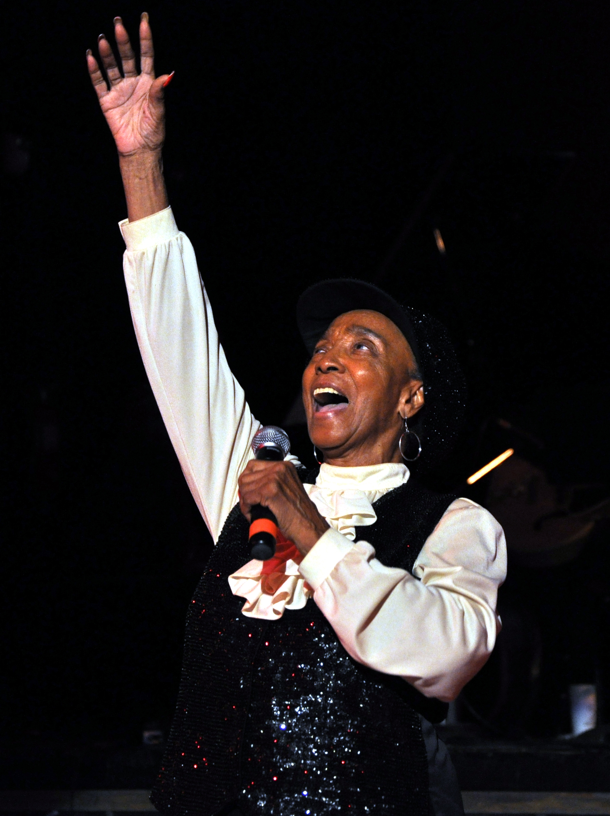 Norma Miller gesturing expressively during a stage performance in Seattle.
