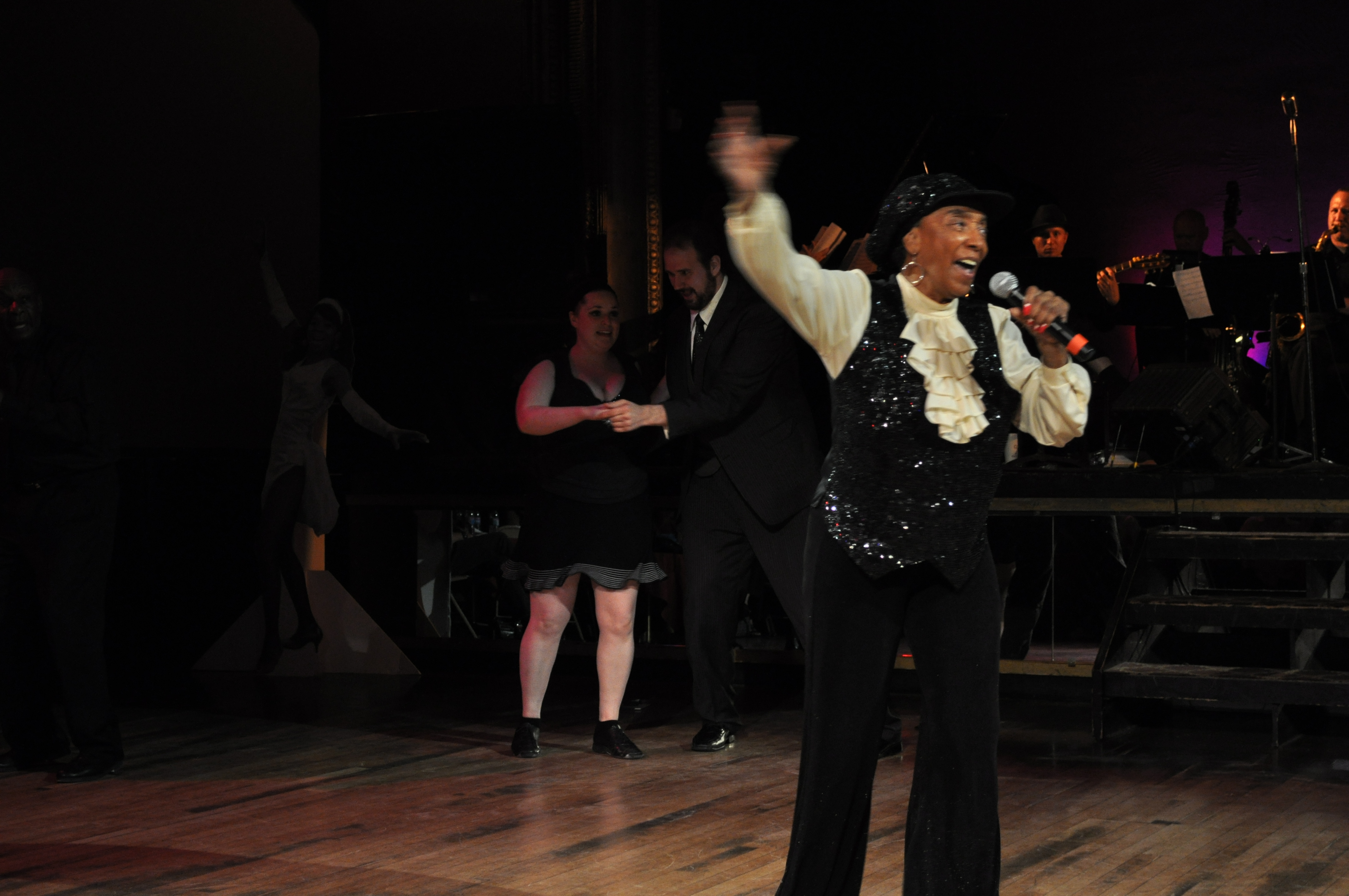 Norma Miller beckoning audience members onto the floor during a performance finale.
