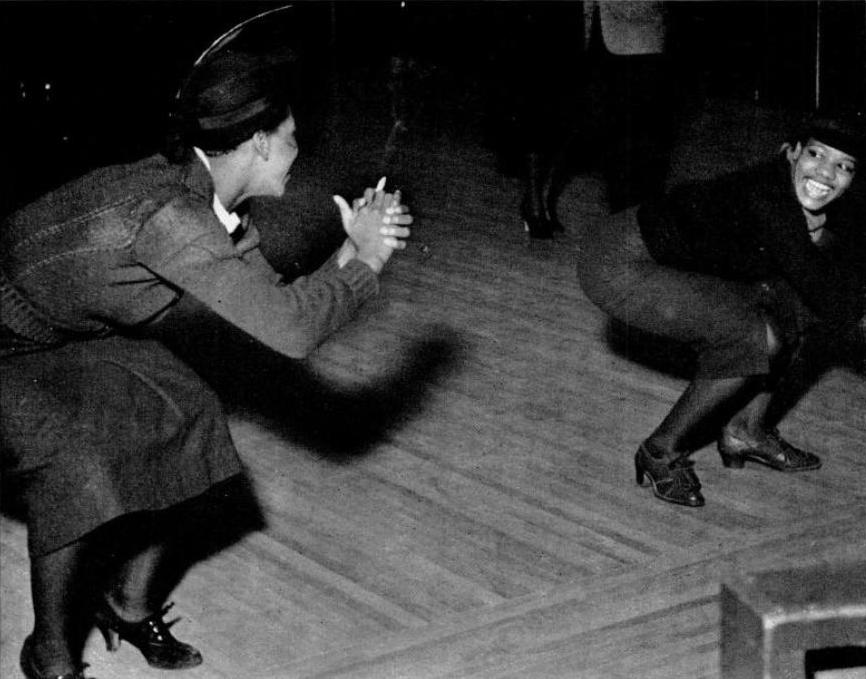 Black-and-white 1936 photograph of women dancing at Harlem's Savoy Ballroom.