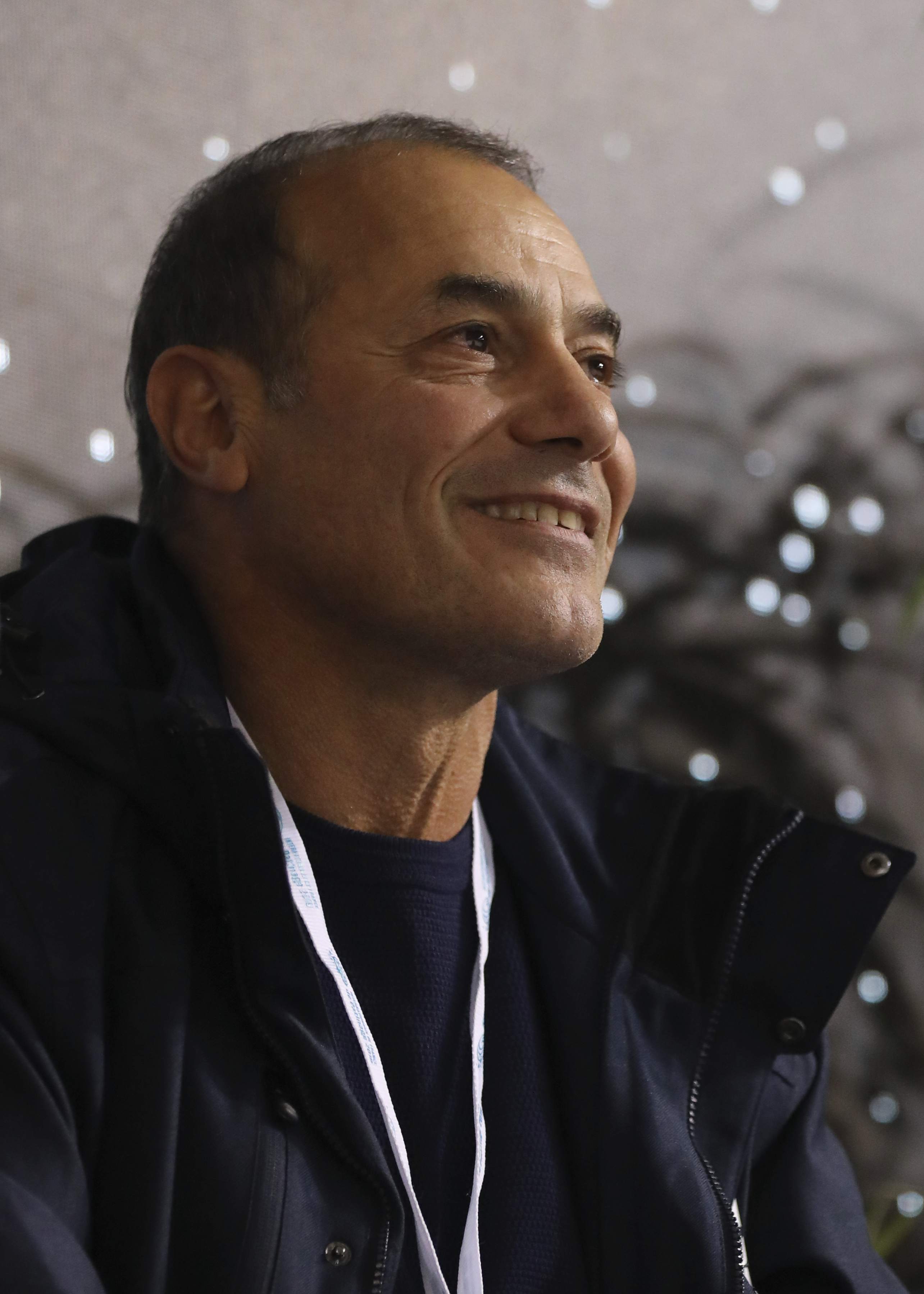Mariah Bell seated with coach Rafael Arutyunyan in the Kiss and Cry at the 2019 Internationaux de France