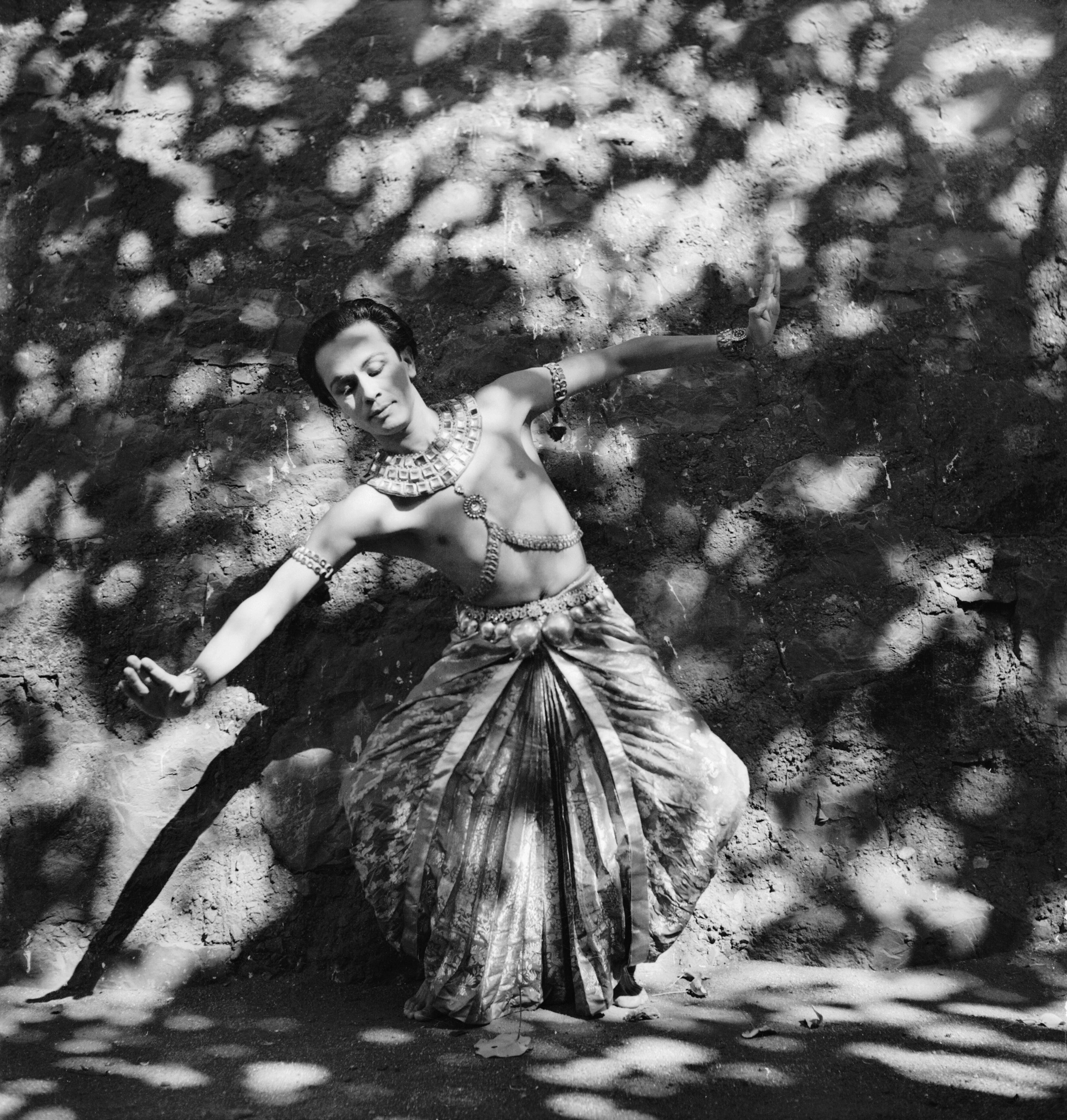 Full-length black-and-white portrait of Ram Gopal in dance costume and a traditional pose in India during the Second World War