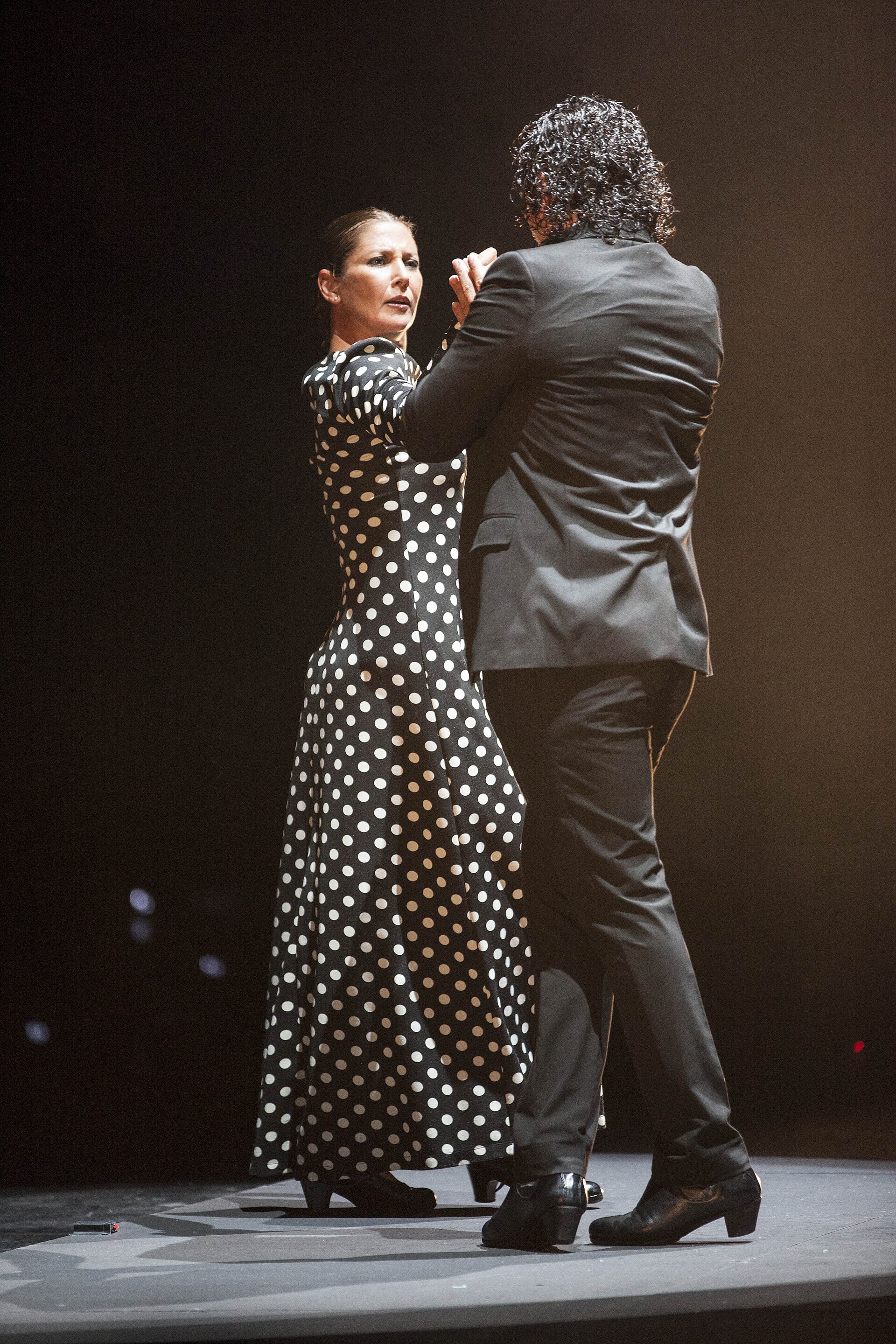 Sara Baras performing in a black polka-dot dress with a male dancer in 2015