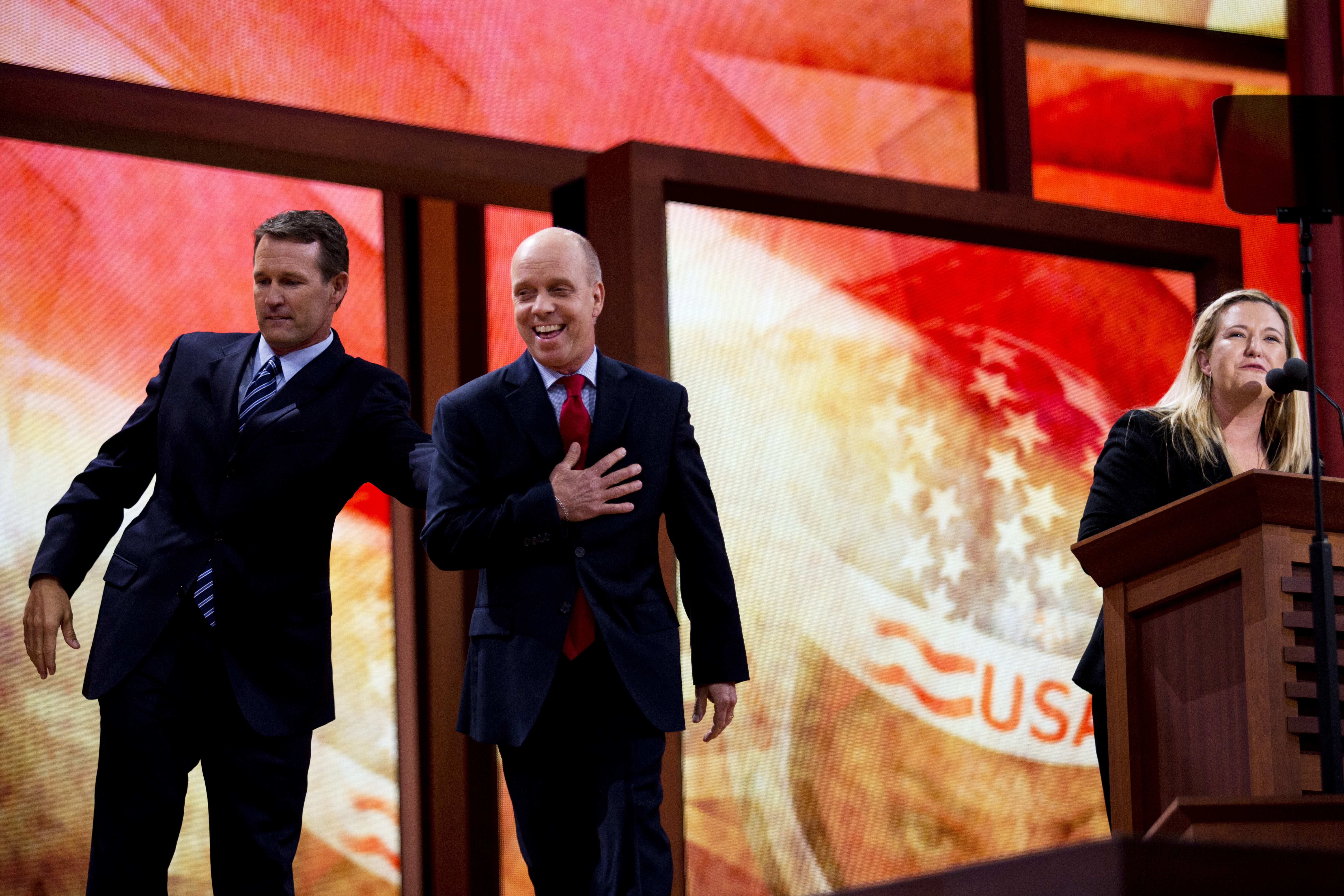 Scott Hamilton entering a political convention stage with fellow U.S. Olympians in 2012