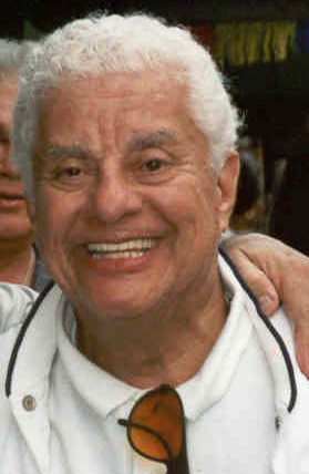Tito Puente smiling in a white shirt at a New York parade
