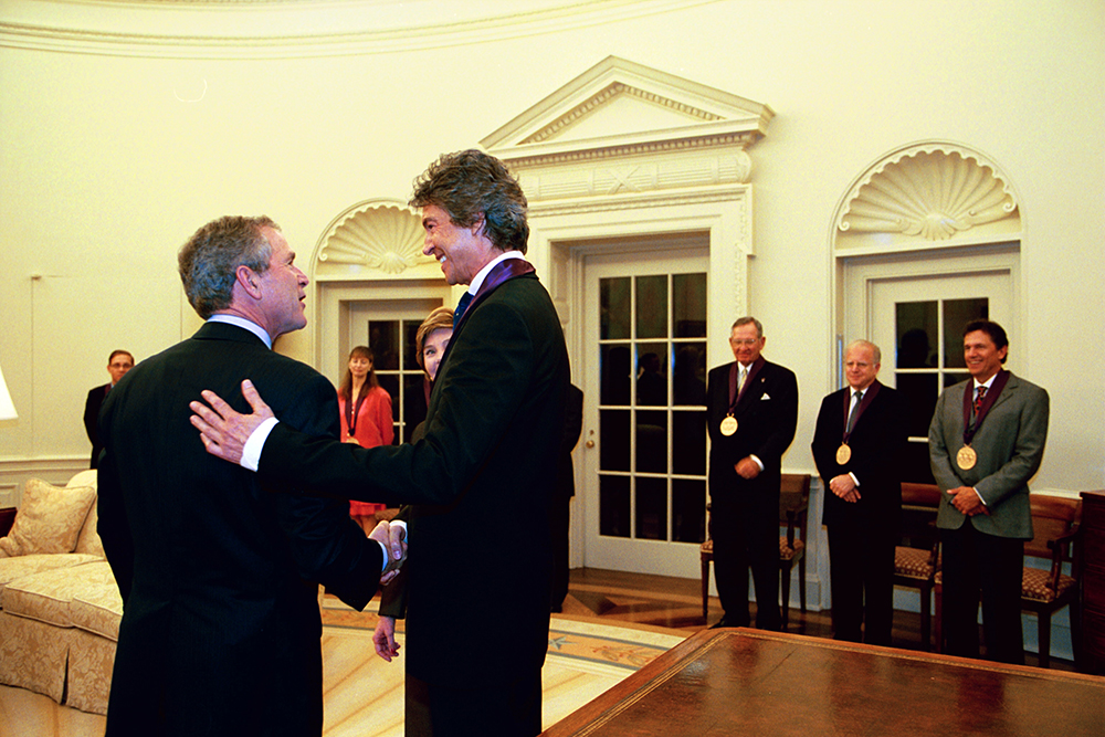 President George W. Bush congratulates Tommy Tune in the Oval Office after the 2003 National Medal of Arts ceremony.