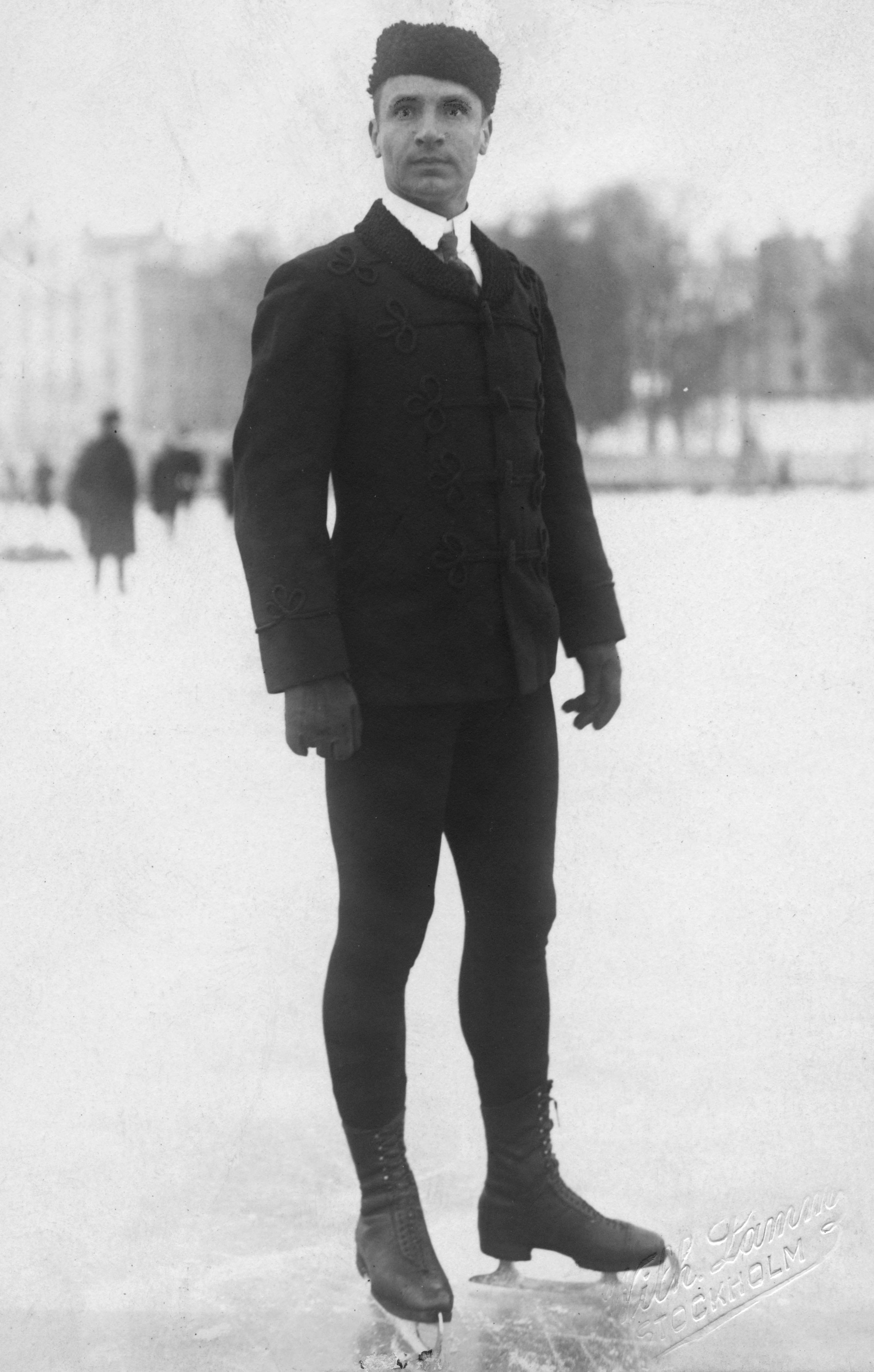 Full-length black-and-white outdoor portrait of Ulrich Salchow wearing skates