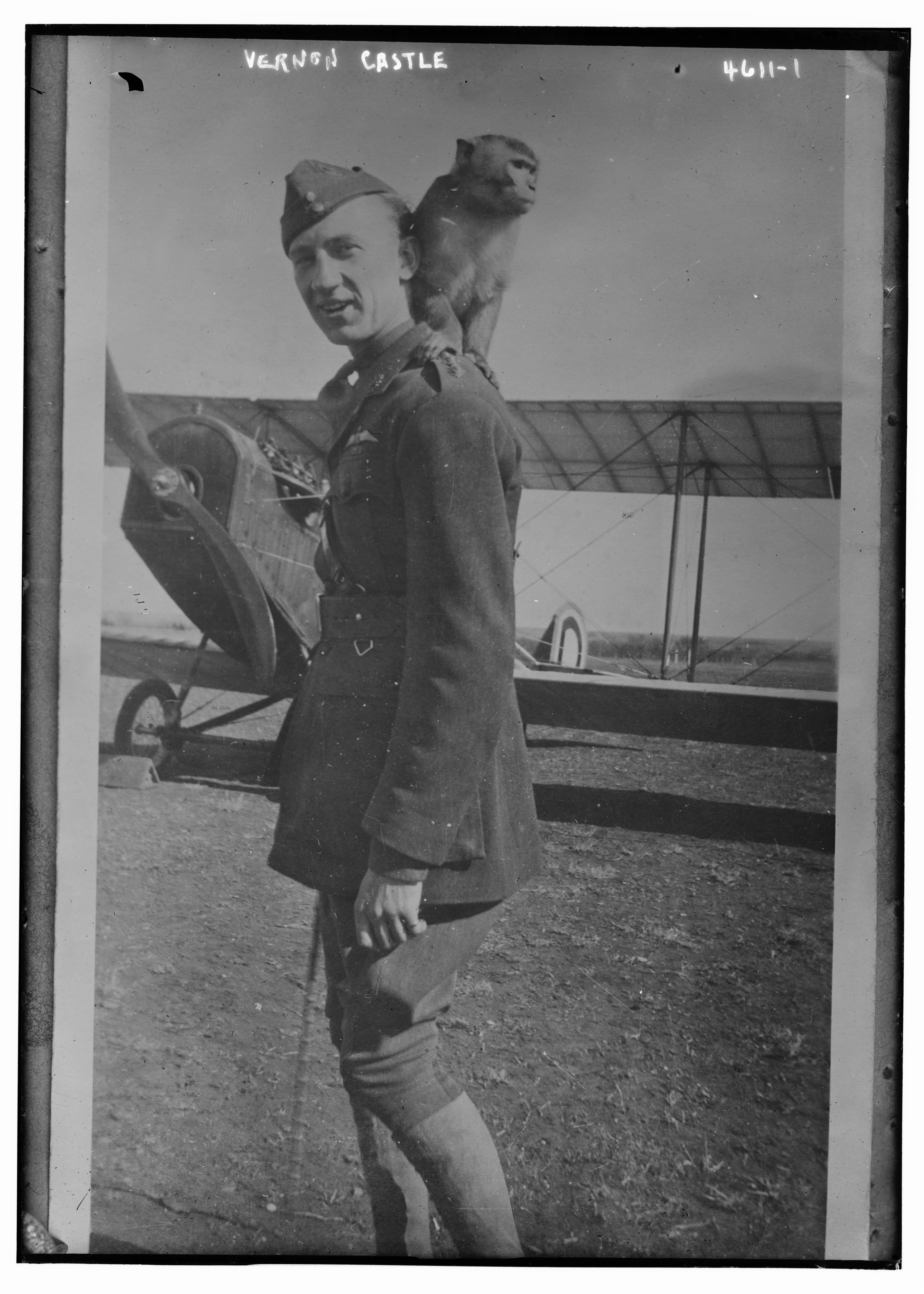 Vernon Castle standing beside an aircraft with a monkey on his shoulder