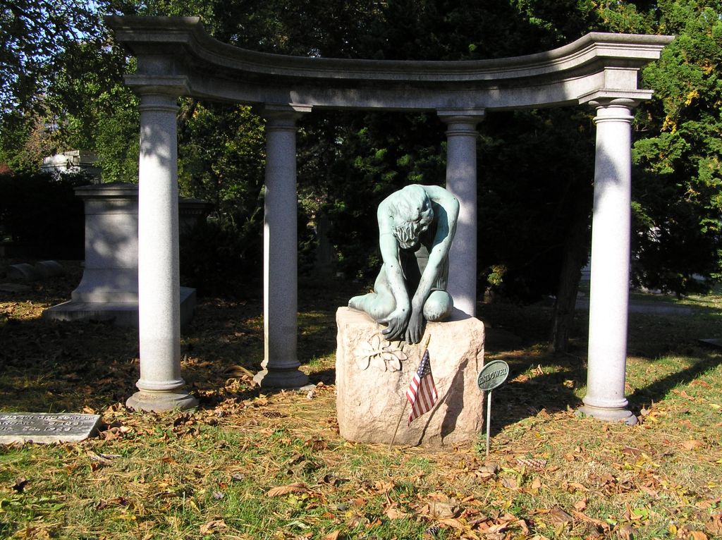 Grave of Vernon and Irene Castle at Woodlawn Cemetery with a kneeling bronze memorial figure